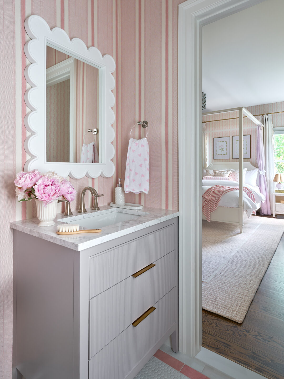 Millwood Road girl's bath vanity with scalloped mirror and pink striped wallpaper